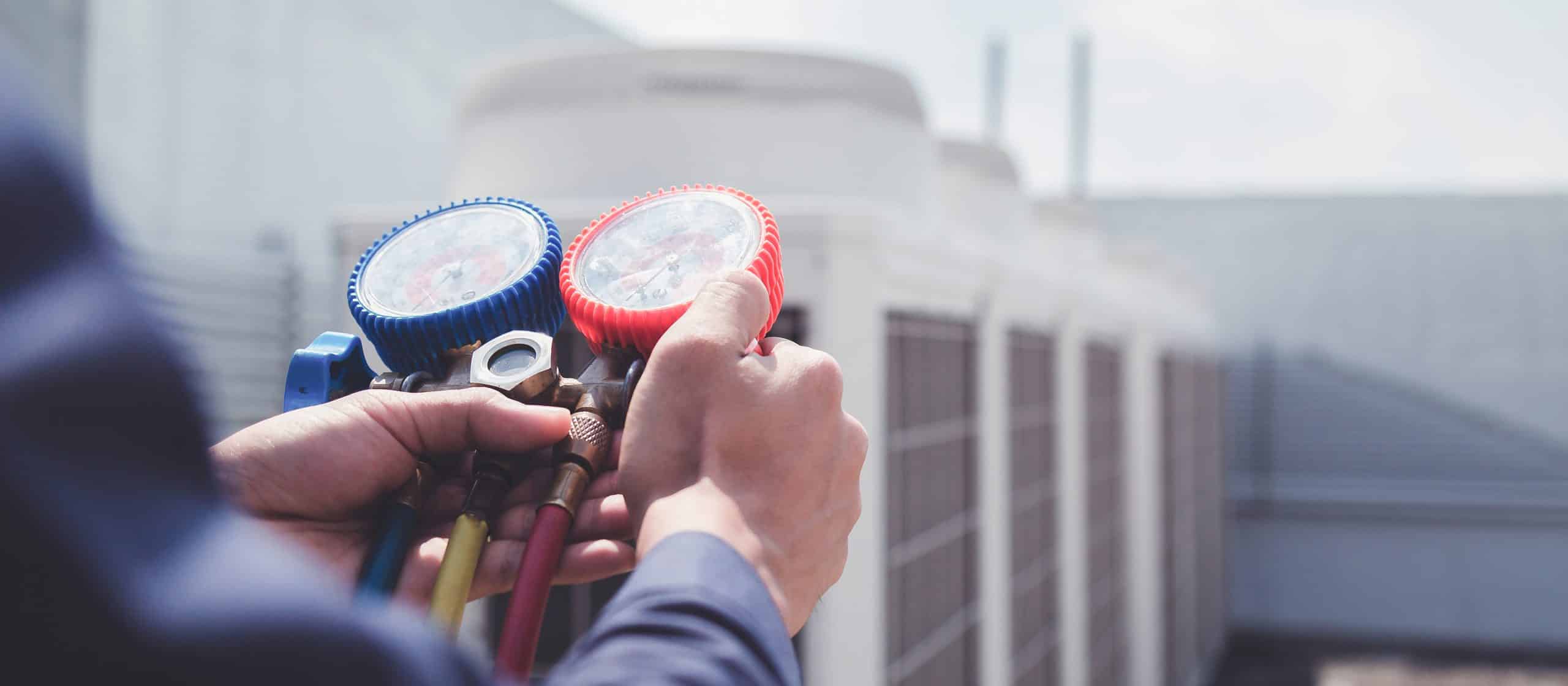Technician is checking air conditioner ,measuring equipment for